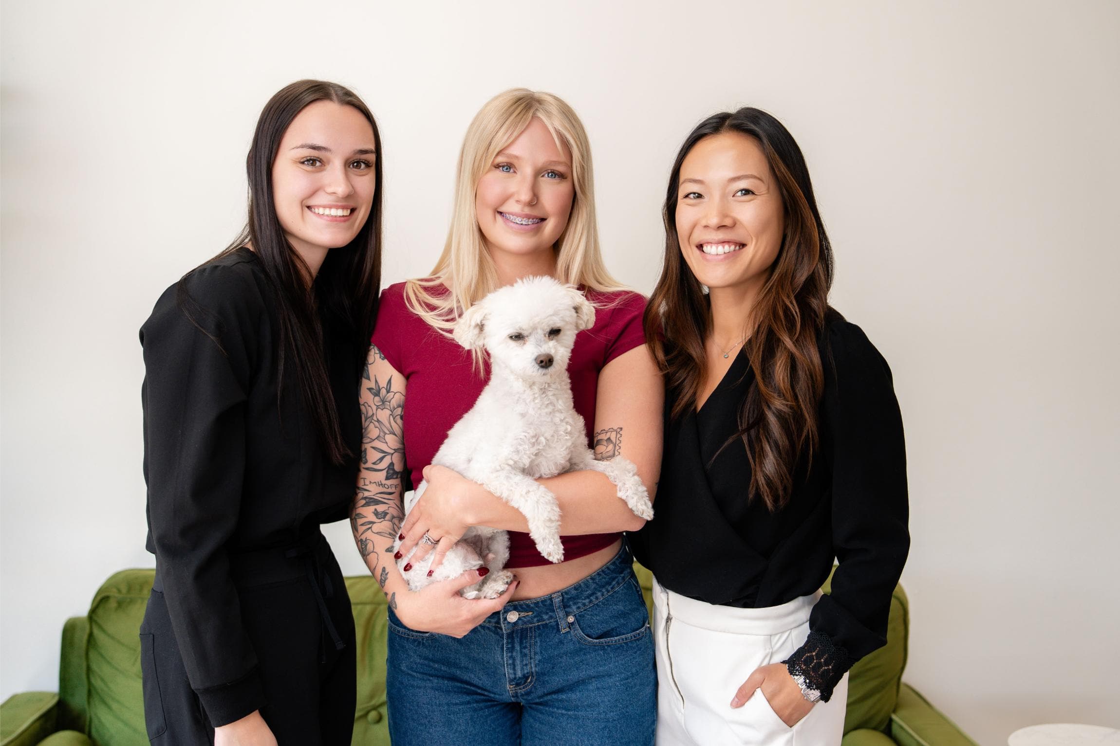 AW Orthodontics team including Dr. Ariel Wong and staff, smiling with a dog.